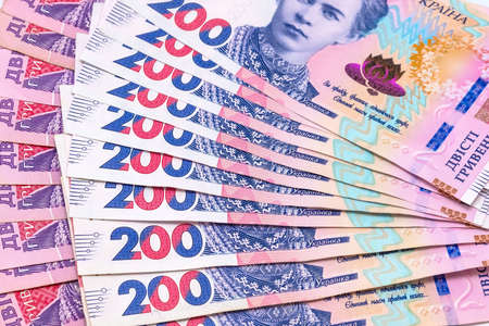 Ukrainian two hundred hryvnia bills arranged in a fan, background. Concept of receiving a salary,...