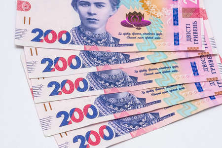 Ukrainian two hundred hryvnia bills arranged in a fan, white background. Concept of receiving a...