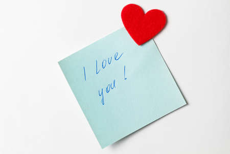A close up of a blue sticky note with the word I Love You with red heart. Valentine's Day. Valentine's Day background. I love you lettering text. love concept.の写真素材