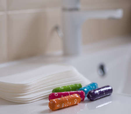 Female sanitary pads and medical female tampons on the bathroom table. Feminine hygiene productsの写真素材