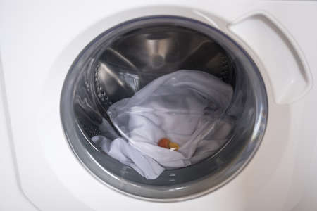Washing machine with laundry and laundry capsule. Washing clothersの写真素材