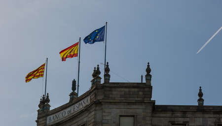 Barcelona, Catalonia, Spain - May 22, 2022: Flags of Catalonia, Spain and the European Union on the bank building. The Bank of Spain Building. Spanish bank in Barcelonaのeditorial素材