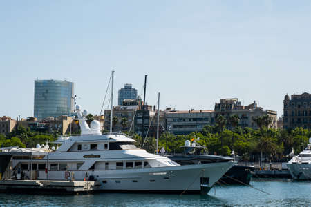 Barcelona, Catalonia, Spain - May 22, 2022: Yachts in Port Vell, city landscape