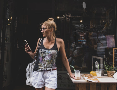Valencia, Spain - August 06, 2019: Tourists in the old area of the city of Valencia, hot summer day, street cafeのeditorial素材