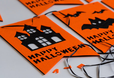 Halloween flags. Black and orange party flags for Halloween decoration on the white wooden desk. Happy halloween festive garland or banner, preparation for the holidayの写真素材