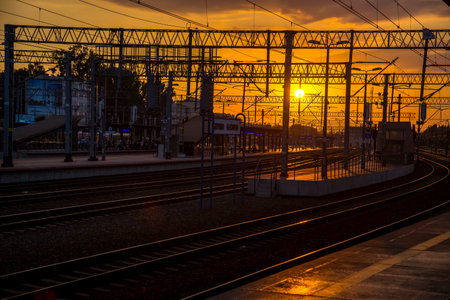 Railway station at sunset in the rays of the setting sun.の写真素材