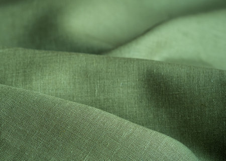 Wrinkled linen cloth folded napkins. Natural linen fabric texture. textured fabric background. Concept of using natural eco-friendly materialsの写真素材