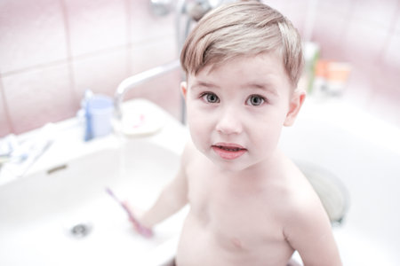 Happy kid or child brushing teeth in bathroom. dental hygiene. going to sleep. close up shotの写真素材