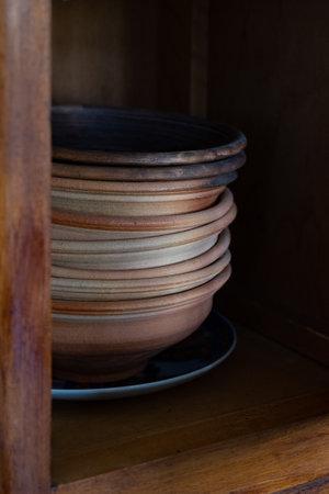 Clay pots in the cupboard. Set of clay dishes, traditional Ukrainian plate, vintage collectiblesの写真素材