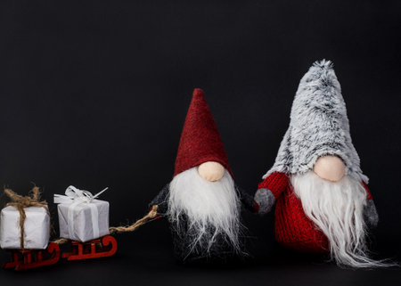 Christmas Gonk carries gifts on a sled. Christmas or New Year concept, greeting card, copy space....