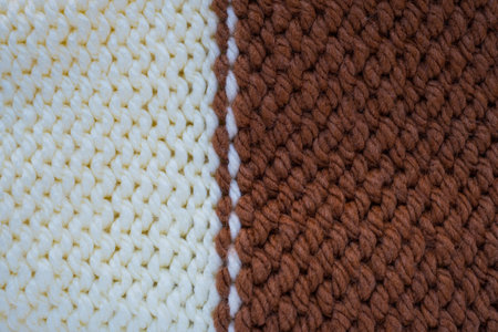 Pattern fabric made of wool. Handmade knitted fabric, white and brown wool background texture. Textured surface, back or wrong side. Warm accessories, clothesの写真素材