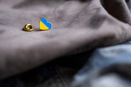 Badge with the flag of Ukraine in the shape of a heart. Ukraine flag theme. Support for Ukraine. War in Ukraineの写真素材