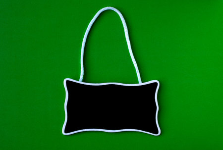 Blank blackboard with white string on green backgroundの写真素材