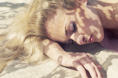 Beautiful blonde and the sun's rays through the laceの写真素材