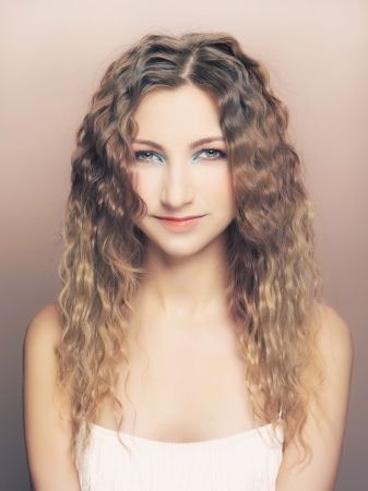 a young beautiful lady with long curly hairの写真素材