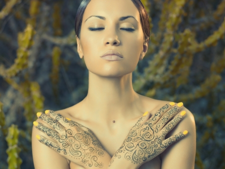 Beautiful young lady with painted hands mehendiの写真素材