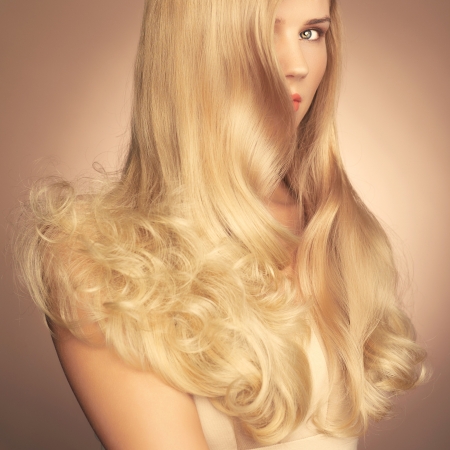 Photo of young beautiful lady with magnificent blond hairの写真素材