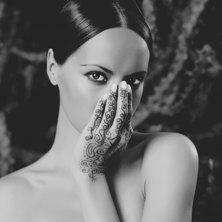 Beautiful young lady with painted hands mehendiの写真素材