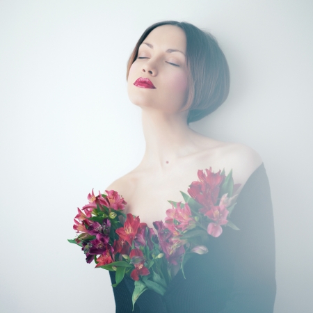 Art portrait of beautiful young lady with delicate flowersの写真素材