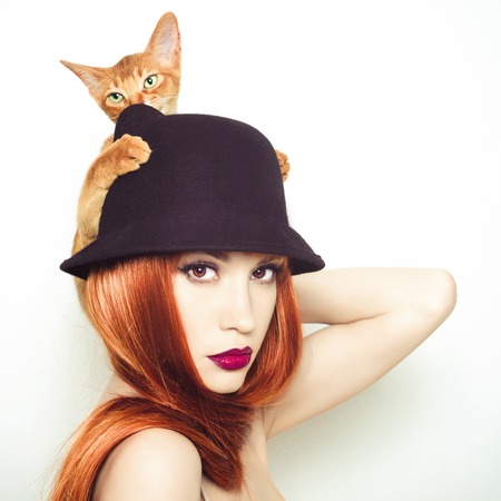 Fashion photo of elegant lady with Abyssinian catの写真素材