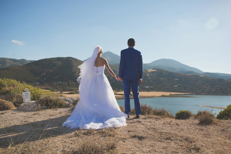Art photo of bride and groom on the seashore. Fashion weddingの写真素材