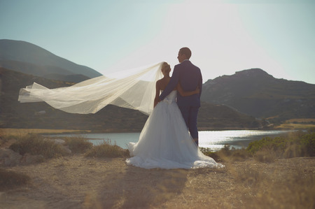 Art photo of bride and groom on the seashore. Fashion weddingの写真素材