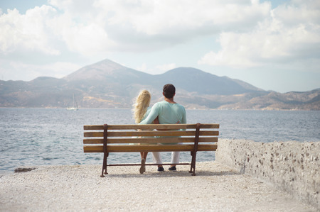 Romantic couple by the sea looking into the distanceの写真素材