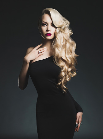 Fashion-art photo of elegant blonde on black background