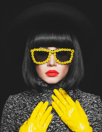 Fashion studio photo of stylish lady in hat and sunglassesの写真素材