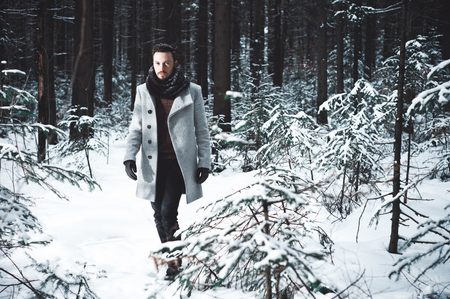 Outdoor portrait of handsome man in coat and scurf. Casual winter fashionの写真素材