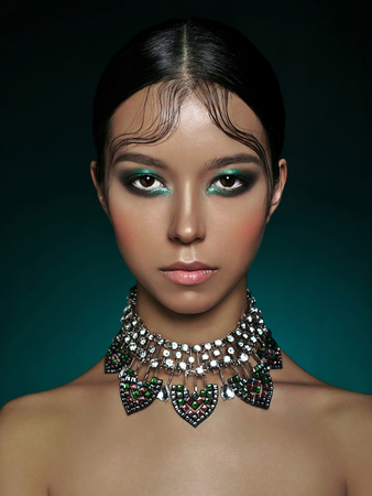 Fashion studio portrait of beautiful asian woman with diamond necklace. Fashion and Beauty. Perfect makeup