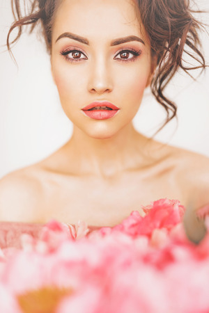 Home stylish fashion photo of beautiful young woman with bouquet of peony. Holidays and Events. Valentine's Day. Spring blossom. Summer season.の写真素材