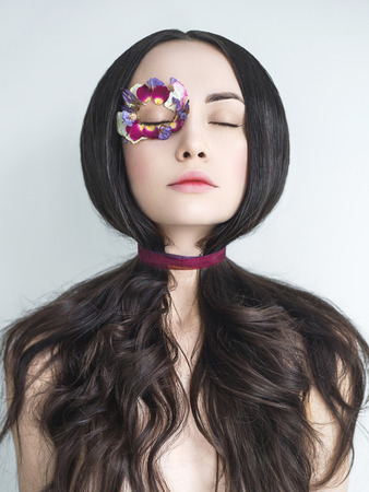 Art fashion portrait of beautiful woman with bright makeup decorated with flowers. Fantasy girl portrait. Summer fairy portrait. Long hairの写真素材