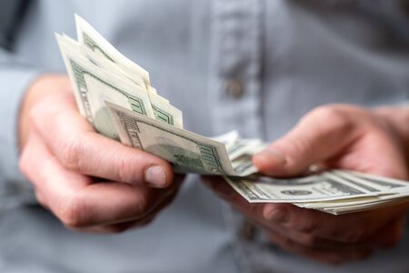 Adult man hands count money dollars.の写真素材