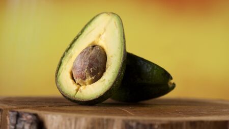 Ripe avocado fruit on a wooden surfaceの写真素材