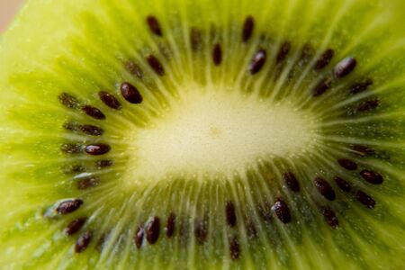 Close-up of slice of ripe kiwi. fruit gives off freshness and juice. fruit for diet and healthy food conceptの写真素材