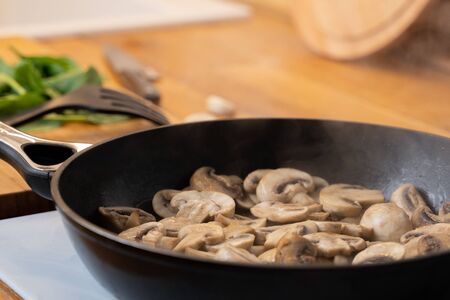 Close-up of mushrooms fried in a frying pan.の写真素材