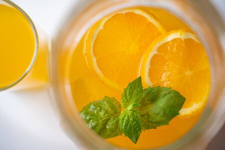 A pitcher of summer healthy lemonade, a cocktail of orange, mint and iceの写真素材