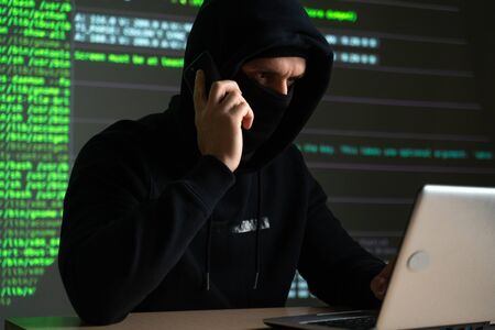 hacker using mobile smartphone calling for victimの写真素材