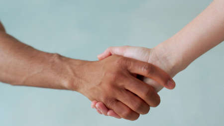 White and black hand connect. Anti-racism. Stop racism, all people are equal. Friendship of Peoples. Black lives matterの写真素材