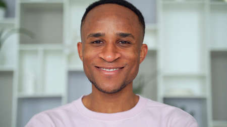 Confident smiling young african businessman looking at camera in office