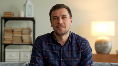 Businessman speak look at camera in office, male entrepreneur talk during conference online call job interview recording online training webinar videoconferenceの写真素材