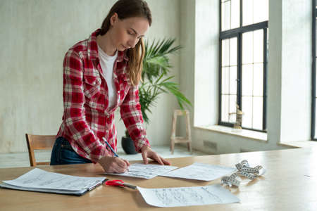 Woman fashion designer hand working in office workshop. Stylish fashionista woman creating new cloth design collection. Tailoring and sewing People lifestyle and occupationの写真素材