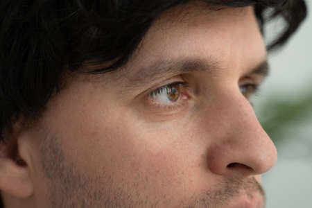 Extreme close-up of a mans eyes looking sideways.の写真素材