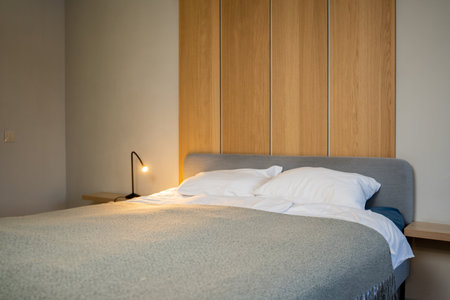 Gray blanket on the bed in the gray interior of the bedroom.の写真素材
