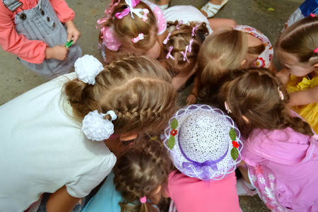 heads of young girls gathering aroundの写真素材