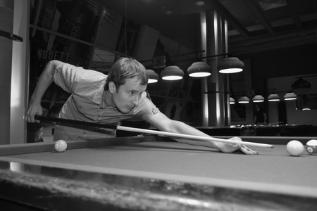 man is playing billiard in the barの写真素材