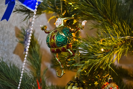 dacoration jester on the christmas tree amongst lights and garlandの写真素材