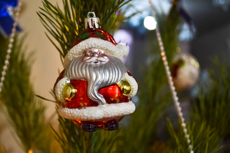 old-fasioned figurine of Santa Claus on the branch of Christmas treeの写真素材