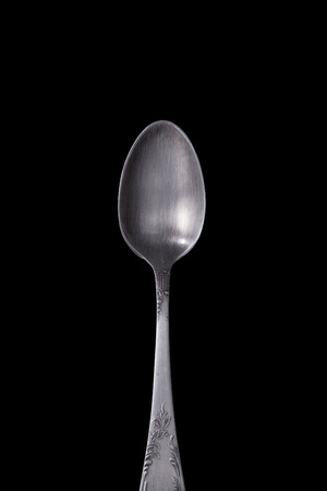 Vintage silver spoon old on a black background.の写真素材